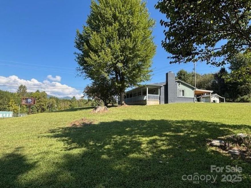 Rustic Charm Meets Modern Luxury-This beautifully remodeled 2-bed/2-bath home was taken down to the shell & completely rebuilt, every detail has been thoughtfully designed for comfort & style. Step inside to stunning hickory floors, an inviting fireplace, an open-concept kitchen featuring granite countertops, brand-new cabinetry & breakfast bar. Each bedroom is a private retreat with its own ensuite bathroom, complete with walk-in tiled showers & elegant tile flooring. Enjoy peaceful mornings or relaxing evenings on the covered front porch. The open, flat yard offers endless possibilities—whether for a dream home setting, business opportunity, or both, as the property is zoned for residential or commercial use. The expansive 1.45 acre lot allows for additional buildings to fit your business needs. Currently, the home is used as an Air B&B but could easily be converted into office spaces.  Centrally located off US-441 entrance to Cherokee & Great Smoky Mountains National Park. With easy access to main roads & local amenities, this home is perfect for those seeking a modernized retreat or business opportunity.