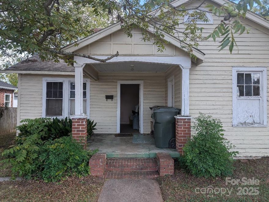 This charming older home is full of character and just waiting for your vision to restore it to its former glory. Featuring 3 bedrooms and 1 bath, this historic downtown Rock Hill residence includes unique details such as an original farmhouse sink in the kitchen and a classic clawfoot tub in the bathroom. The property sits on a generous lot with  fenced backyard and a storage building, offering plenty of outdoor space. Whether you're searching for a personal home, a fix-and-flip project, or a rental investment, this home is brimming with potential. Come view and imagine the possibilities.
