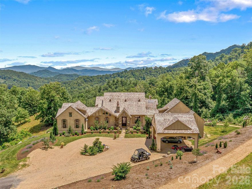 A Country Estate & Mountain Retreat, in the Blue Ridge Mountains, designed for those seeking ultimate privacy, beauty & a true Sense of Place. Home Set at 3,560 feet elevation on 43 acres,(top of property is 3900 elevation), breathtaking LONG RANGE MTN VIEWS. Southeast-facing, offers cool summer temperatures, fresh mountain air, & the rare feeling of floating above the clouds. You can see all the way to Tennessee on a clear day. Privacy is unparalleled—no neighboring homes visible during summer  & only 1 in winter, creating a peaceful, secluded sanctuary of safety. Ideal for either a primary estate or luxury 2nd home retreat. The land itself is remarkable, featuring abundant natural water-multiple springs, creeks/streams & ponds for relaxation. Rolling pasture land & gently contoured hills make the perfect fit for Biophilic walking & hiking trails, 4-wheeler trails, & open spaces that invite you to explore nature. A natural habitat of wildlife, wildflowers, & native mountain laurel provide stunning seasonal beauty. The residence itself, professionally designed, blends refined craftsmanship with effortless mountain living. A true chef’s kitchen anchors the home with a La CornuFe dual-fuel range, 2 refrigerators, 2 dishwashers, skylights that flood the interior with light. Beautiful wood burning fireplace in kitchen creates warmth & ambiance throughout. This is 1 of 5 fireplaces, also complemented by an outdoor fireplace & fire pit for evenings under the stars. Butlers Pantry has open shelves for ultimate storage & 1 of 3 laundry stations. Dining Room & Library (also with fireplace), perfect for lounging. Main primary bedroom suite offers luxurious living with a gas fireplace, cathedral ceiling & a wall of windows that allow star gazing from bed, & private covered deck.  Primary bath offers a extra large marble shower, (with door to an outdoor shower) a Victoria + Albert free standing tub, & a huge walk in closet. 2nd Primary suite also with large cathedral ceiling & private covered deck, small kitchenette, sitting area, bath with Victoria + Albert tub, & large separate shower. 2 additional guest rooms, 1 on main and 1 in lower level, all with private baths & showers. Top of the line Ultimate Marvin windows and doors frame panoramic long range views from every room, seamlessly connecting indoor and outdoor living. Multiple covered decks and a spacious covered back porch provide ideal spaces for quiet mornings & evening year-round enjoyment of the mountain setting & views! This property is all about the views! An additional lower level space, (now being used for extra storage), could be the perfect artist studio, gym, yoga or meditation studio. A rare private mountain sanctuary, rich in feeling. Conveniently located approx 10 minutes from I-26 and approx 25 minutes from historic Asheville. Also home to Mount Mitchell—the highest peak east of the Mississippi! Fun fact, (Yancey County) has more artist per capita than any state in the US. Also offers, Best fly fishing streams, Rivers, rafting, hiking trails, waterfalls, & gem mining, just minutes away. Skiing & Golf, (20 minutes away) -Great restaurants and Breweries within 15 min.
(Possible option to purchase a membership at a nearby Resort Community for additional amenities)  If you are searching for the perfect mountain escape, this is it. Imagine waking up to the quietness of only birds chirping, the deer roaming, & where time seems to stand still. Property would also be an amazing equestrian farm, or Animal rescue center. Tons of space for multiple barns! If you are looking for additional income, Property would also make an Amazing Event center or Wedding Venue. If you are looking for an STR investment property, this could be a very high end rental property. A Preppers Haven. Home is sensual in all ways! It’s ALL in the feeling! (Broker Owned )-Owner would consider partial owner financing.   
Please see attached feature sheet for complete details  https://youtu.be/_Q43AJeG2_0