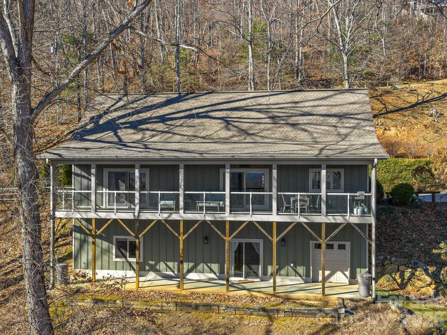 VIEWS! VIEWS!! VIEWS!!! HAYWOOD COUNTY WNC FULLY FURNISHED TURN-KEY DREAM HOME ON 1.84 PRISTINE PRIVATE ACRES WITH BREATHTAKING LONG-RANGE MOUNTAIN VIEWS! Experience refined mountain living at 26 Ashewood Lane, a move-in-ready luxury retreat with panoramic mountain views. This meticulously maintained home seamlessly blends elegance, comfort, and versatility—perfect as a primary residence, second home, or successful vacation rental. The main level showcases an open, light-filled floor plan with a spacious living room, gourmet kitchen, and serene bedrooms. The upper level offers private guest accommodations, while the lower level provides versatile living and additional guest space, ideal for entertaining or multi-generational stays. Step onto the expansive deck to savor your morning coffee or sunsets amid tranquil wooded surroundings and stunning mountain vistas. Thoughtful design, ample parking, and easy access complete this exceptional property. Nestled near shopping, dining, hiking, and the Blue Ridge Parkway, this home offers a rare combination of luxury, versatility, and proven rental performance in coveted Western North Carolina.