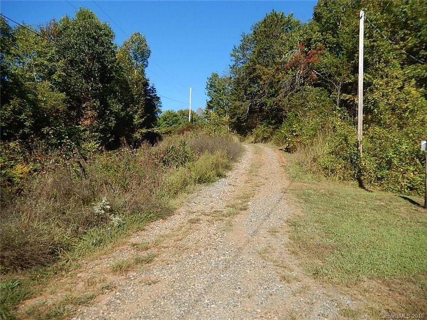 Two adjoining lots of record set back from Windswept Ridge. 1.03 acres and 1.23 acres. One with older single wide and shed. Title to single wide to be conveyed for $1.00. Other lot is flat and ready for double wide or other home. Septic, well and power are in. Very nicely lying with southern long range views, yet bounded by tall pines and hardwoods; garden space; private yet 5 minutes in to Marshall, shopping, schools. Priced fairly to sell quickly out of the estate.