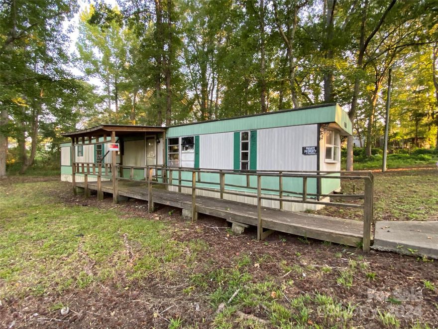 INVESTOR SPECIAL!!! This isn't just a mobile home, this is a character building opportunity! Are you tired of boring, solid floors? Buy now and discover refreshing indoor rain shower experience, no extra charge! Do you crave a property that's as full of surprises as a lottery ticket? Look no further because with every step in this home is a thrilling adventure! It's situated on two lots that total .8 acres, & has a stream that runs through the front of the property offering the soothing sounds of nature. The opportunities are endless: you can fix up this home and use for a rental, add an additional home or tear down and start from scratch & build 2 homes. Don't miss out on your ticket to a truly unique and unforgettable opportunity. Home to be sold as is.