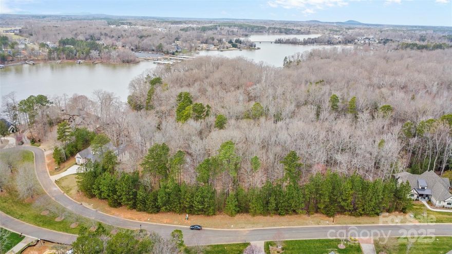 A special opportunity to have lake views from your backyard! This .45 acre cul-de-sac lot offers stunning views of the cove extending to Lake Wylie's main channel. Perfect for a walkout basement home, build with one of our Featured Builders or bring your own (subject to qualification). Nestled deep within the community, this lot is within walking distance to the marina and recreation field. Reflection Pointe amenities include clubhouse, pool, tennis courts, paved trails, recreation field, waterfront pavilion, marina/beach area, and on-site boat storage. Just 10 minutes from downtown Belmont. Enjoy a 30-minute commute to Uptown Charlotte or 20 minutes to the airport. With no build timeline requirements, secure your lot now or save it for a future build. Surrounded by the beautiful waters of Lake Wylie, this community offers a lifestyle that's truly exceptional!