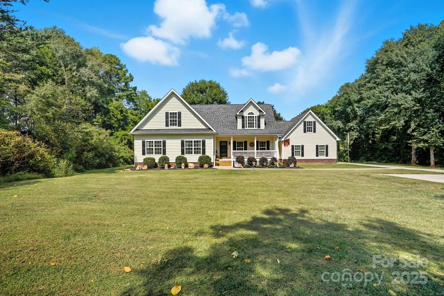Welcome home to this one owner home on almost an acre home site that has been well cared for and nestled privately just outside Charlotte minutes from 485 and other major roadways, shopping & dining.  Schedule your appointment to view because this home has too many features to list them all here.  Our favorite features include, NO HOA DUES, the large front porch and deck roomy enough to hang out with family and friends that was refreshed in 2025, large garage with attic access that has been floored and braced for extra storage, updated neutral paint throughout in 2025, water heater updated 2021, HVAC updated in 2017 and 2025, connected great room, dining, and kitchen with large island for prep and entertaining with a window overlooking the backyard, spacious primary suite with TWO walk-in closets and en suite bath with framed mirrors, 2 sinks, water & linen closets, and separate garden tub & shower, comfort height toilets and updated plumbing fixtures, media room with surround sound, the upstairs rooms have added character with nooks, this home also has flood lights, ring doorbell, an inside camera and outside cameras.  The washer and dryer, some furniture, and more can remain with acceptable offer. Sellers recently had septic pumped 11/25 with the septic upgrade and garage door serviced in 2025 as well.