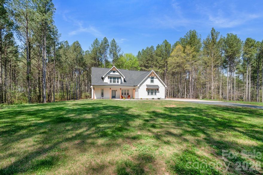 Almost New Modern Farmhouse on Nearly 2 Acres Surrounded by Beautiful Pines in Marshville!

Built in 2024, this beautifully crafted custom home offers the perfect blend of modern design and peaceful country living. Relax on the spacious covered front porch with cedar columns and watch the sunrise while enjoying your morning coffee overlooking the quiet natural surroundings. Inside, you'll find a spacious family room with a soaring 12-foot ceiling, an open layout perfect for entertaining, and custom Red Oak stair railings and steps that add warmth and character. The kitchen is the heart of the home, featuring a large 7-foot island with seating, tile backsplash, white shaker cabinets, stainless steel appliances, a breakfast area, and pantry. The refrigerator, washer, and dryer convey, making this home truly move-in ready. The Primary Suite is conveniently located on the main level, offering privacy and comfort. This inviting retreat includes tray ceilings, a cozy reading nook, and a spacious walk-in closet with a professional closet organization system. The Primary Bathroom features a frameless glass tiled shower, freestanding soaking tub, and a 72" double vanity. Upstairs you’ll find three additional bedrooms with one being oversized and a versatile bonus room, providing flexible space for guests, hobbies, or a home office. Since purchasing the home, the owners have added several thoughtful upgrades including custom blinds throughout the entire home (including doors), a whole-house water filtration system, and LeafFilter gutter protection. LVP flooring for the upstairs bedrooms is still in the box and will convey with the home should the new buyer wish to replace the current carpet. Tucked among beautiful mature pines on nearly 2 private acres, this home offers peaceful country living while remaining conveniently located to Monroe, Oakboro, and Locust. Located in the desirable New Salem/Piedmont School District, it provides the perfect blend of privacy, space, and accessibility.