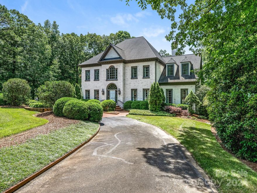 Beautiful Georgian nestled in one of Charlotte's most attractive neighborhoods! This stately home features high ceilings, beautiful hardwood floors, fresh interior paint and is in immaculate condition.  The elegant foyer is flanked by the living and dining room.  Stunning kitchen with quartz countertops, stainless steel appliances, shop built cabinets and large breakfast area. The great room flows into the covered terrace with grilling station/bar and provides excellent sight lines of the pool, spa and outdoor fireplace. Main level primary suite has dual closets, walk in shower, and soaking tub. 
Two sets of stairwells lead to the upper level bedrooms, office (with fireplace), secondary playroom and bonus room.
Permanent steps to attic allows for easy and ample storage--and a whole house generator!!