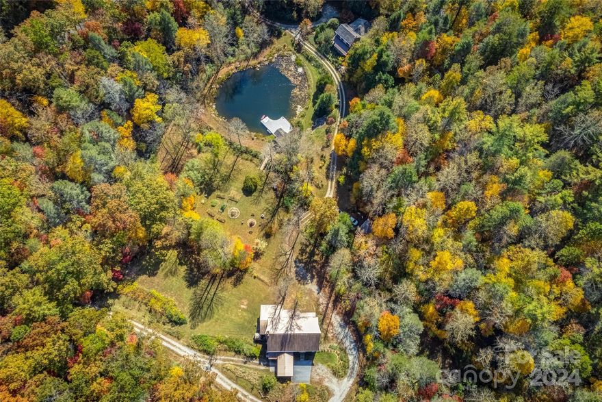 ONCE IN A LIFETIME PROPERTY | PRIVATE RESIDENCE AND/OR RETREAT/EVENT CENTER ON 49.23 PRISTINE ACRES 30 minutes to Asheville and 40 minutes to Greenville SC. Idyllic 2007 main farmhouse with a tranquil porch overlooking the stream-fed pond. Indoor & outdoor stone fireplaces, dream kitchen, & artisan craftsmanship throughout. 2014 "Barn" with open space for events, commercial bathrooms, large event kitchen, bedroom with full ensuite bath, lower level recreation and storage space, and an expansive covered porch with a pizza oven overlooking the grounds. Additional studio building perfect for office or hobby space. 49.23 glorious acres with a pond, trex pond dock, gazebo, trail, bold stream, waterfalls, rhododendron groves, open spaces, gardens, and breathtaking stonework. Site plan available for future building and recreation sites on the property. Make this your own private two home sanctuary, or realize your dream of owning a Blue Ridge mountain event/retreat property. Sold furnished!