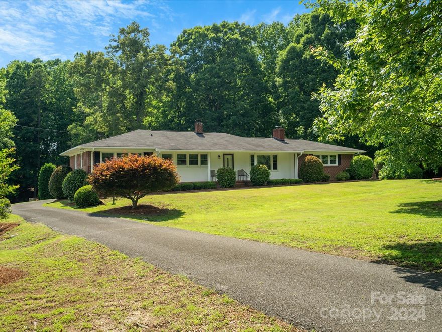 Location, location, location! This classic brick ranch is perfectly situated on 2 picturesque acres! It’s a treasure trove of times past with the potential to be updated with all the modern feels or move right in and appreciate the nostalgia that surrounds you! You will fall in love with the gorgeous setting and the love that has been put into keeping this property one of the area's most scenic parcels! The 3 bedroom/2 bath home boasts a formal living room with a gas fireplace, formal dining room, roomy eat in kitchen with lots of custom cabinetry, an expansive sunken great room with custom built-ins and another gas fireplace! Enjoy all of our sweet southern seasons from the front porch or back patio! There's room for all your tools and toys in the detached garage with a large workshop.  All located in the award winning Clover School District and close to downtown Clover, SC! Hurry home to 1015 Saint Paul Church Road, you will not want to miss this one! Property is being sold as-is.