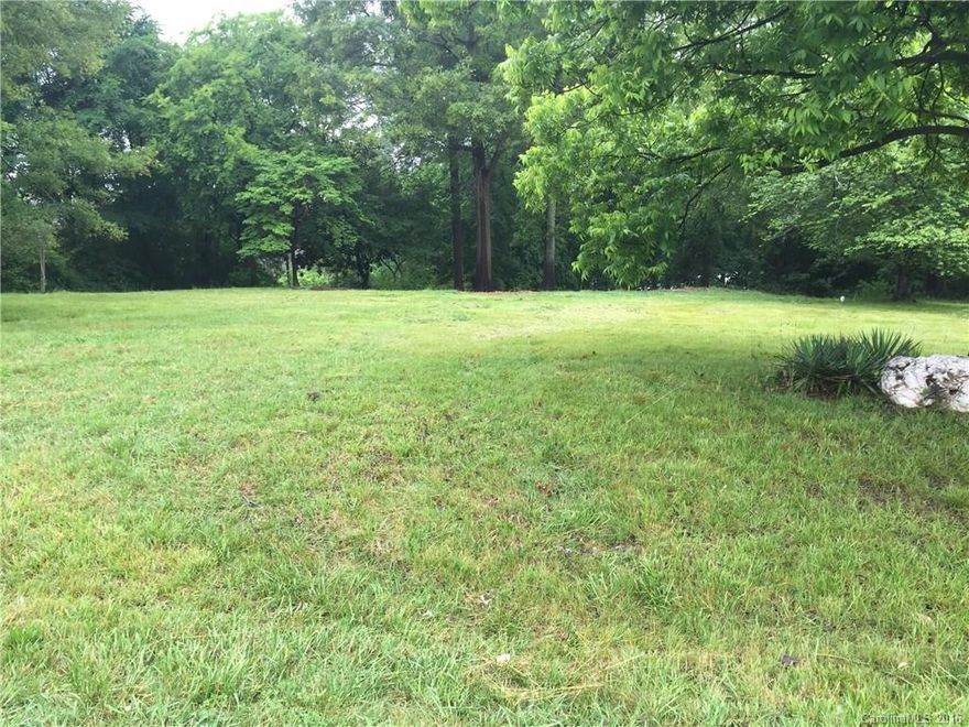 GREAT LOCATION.  Corner lot in quiet neighborhood. .  Very near to George Liles Parkway, 
Afton Village and Interstate 85.   Beautiful flat lot with established tulip tree and irises on property.