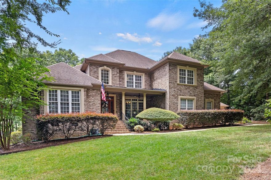 This beautiful all brick custom home sits on over an acre with views of Lake Wylie from the front AND the back yard. You will love the amazing flow of this home that features primary and guest suite on the main level, a two story family room with tons of natural light, cozy fireplace with built in bookshelves. There is a formal dining room with easy access to the gourmet kitchen with an island, gas cooktop, sunny breakfast area, opening into the keeping room with a second fireplace. The primary suite has an elaborate double tray ceiling, beautiful bath with vaulted ceiling, dual sinks, separate shower and garden tub also a door leading to the back deck.  Upstairs you will find two ensuite bedrooms with private baths, and a bonus room that could be used as the 5th bedroom and an extra room perfect for crafting or storage.  There is a double two-car garage providing even more storage space.  Enjoy your evenings on the deck, screened porch, patio w/FP and the fully fenced backyard.
