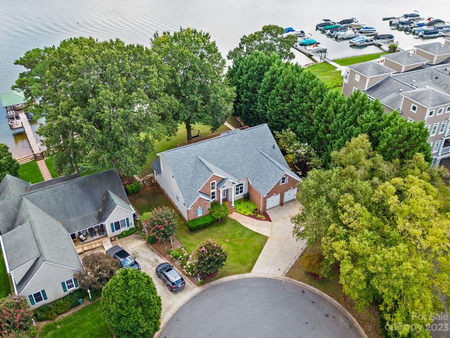 Step into this magnificent waterfront residence situated on the picturesque shores of Lake Norman. Upon entering, you'll be welcomed by a generously proportioned foyer that leads to an expansive living space showcasing oversized windows that frame the breathtaking waterfront views. The well-appointed gourmet kitchen boasts stainless steel appliances, quartz countertops, and seamless access to the sprawling deck that affords commanding views of the lake. Enjoy morning coffee in your main-level primary suite overlooking beautiful Lake Norman. The upper level is dedicated to three bedrooms and two bathrooms, with an open loft area that gazes down upon the foyer below. Outside, a fully fenced yard encompasses an oversized multi-level deck, lush landscaping, and a private dock. This property offers an oasis of privacy and tranquility, all the while maintaining the utmost convenience, just minutes from shopping, dining, and entertainment options that Mooresville has to offer.