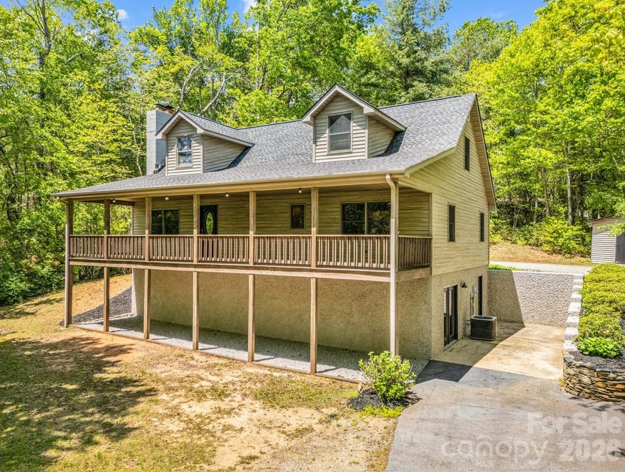 Tucked away on approximately 2.5 acres of wooded beauty, this mountain retreat offers peace and privacy. A winding driveway leads you home, where winter mountain views and birdsong set the scene for quiet mornings and cozy evenings. Just a short drive from the charm of downtown Saluda, NC, nearby Hendersonville as well as Greenville, SC.  Seclusion without sacrificing convenience; here, you’ll enjoy the best of both worlds!
The open floor plan features a generous living room with vaulted ceilings and a striking stone fireplace complete with a Buck Stove insert—perfect for gathering around on chilly nights. The open loft above offers flexible space for an office or reading nook, while the full, unfinished basement is brimming with potential. With three bedrooms and two bathrooms, there's room for everyone to feel right at home! Easy flow for entertaining or to enjoy as a private mountain getaway, yet convenient to area amenities and daily essentials.
Whether sipping coffee on the covered front porch, planting a garden, or exploring your own private slice of nature, this property invites you to slow down and stay awhile.