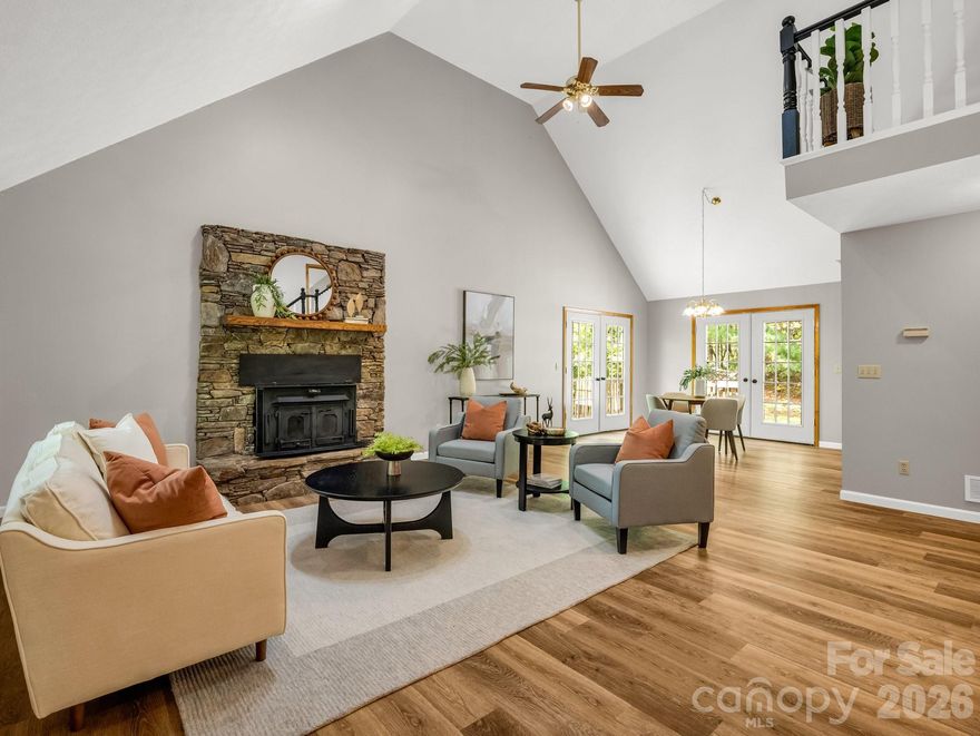 Tucked away on approximately 2.5 acres of wooded beauty, this mountain retreat offers peace and privacy. A winding driveway leads you home, where winter mountain views and birdsong set the scene for quiet mornings and cozy evenings. Just a short drive from the charm of downtown Saluda, NC, nearby Hendersonville as well as Greenville, SC.  Seclusion without sacrificing convenience; here, you’ll enjoy the best of both worlds!
The open floor plan features a generous living room with vaulted ceilings and a striking stone fireplace complete with a Buck Stove insert—perfect for gathering around on chilly nights. The open loft above offers flexible space for an office or reading nook, while the full, unfinished basement is brimming with potential. With three bedrooms and two bathrooms, there's room for everyone to feel right at home! Easy flow for entertaining or to enjoy as a private mountain getaway, yet convenient to area amenities and daily essentials.
Whether sipping coffee on the covered front porch, planting a garden, or exploring your own private slice of nature, this property invites you to slow down and stay awhile.