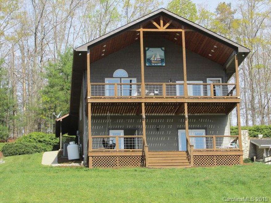 $25,000 PRICE REDUCTION!!!  Watch the sun rise every morning across the lake! Great long water views of Lake James. Perfect lake cottage for entertaining with large great room, kitchen with cherry cabinets,master suite on main. Large guest suite/bath in lower level,2 additional bedrooms with Jack and Jill bath.Views from every window. 2 Levels of large decks for fun in the sun! Very easy,LEVEL walk to the lake, deck by the water and your own sandy beach. Covered boat dock with trex decking,hydrolift,jet ski pad and storage closet. Outdoor shower.