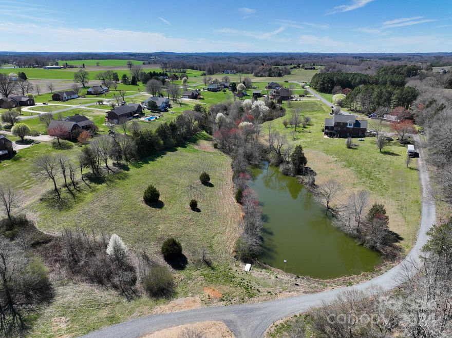 This 3.92+/- acre property in the desirable Westridge community in Albemarle features a large, cleared build site overlooking a private pond. At the end of Jordons Pond Dr, a paved driveway leads from the cul-de-sac to the subject property through a 20’ wide driveway easement,  leading you to a clearing that reveals a stunning homesite. A 5 bedroom Septic permit has been issued by the NC Department of Health & Human Services (see attachments). Covenants require homes to be brick veneer, stone, or stucco with minimum HLA of 1,350 sqft for a 1 story home and 2,000 sqft for a 2 story home. Power and water are available on Jordons Pond Dr, but a private well may be preferred based on the final home location you choose. Property is located less than 10 minutes to downtown Albemarle and less than an hour’s drive from center city Charlotte. This premium homesite offers a unique blend of natural charm and modern convenience.  Will not be available long, call today to learn more!