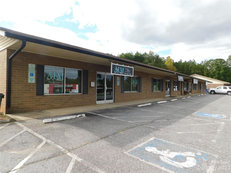 HIGH VISIBILITY commercial strip center containing 2 buildings on 2.81 acres +/- in the city of Stanley.  Each building is 4800 sq ft (four 1200SF units each). One building is individually metered for water and sewer, the other on one meter.  All units have gas heat, central air. Exterior is brick veneer with vinyl trim, fiberglass shingle roof.  Each unit has a half bath and separate water heater.  a total of 46 parking spaces are located on a paved lot in the front, including handicap parking. Property has been well maintained.