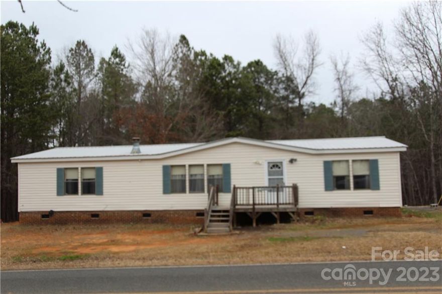 Manufactory home on 1.2 acres of land.   Home does need some repairs and sales as is.  Over 1800 
of heated space and no city taxes.  Home has a nice outbuilding that stays.  Call for appointment. Metal
roof is approximately 6 yrs old.