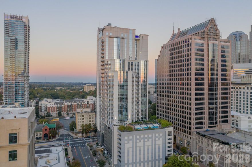 Experience elevated Uptown living in this beautifully renovated 2-bedroom, 2-bath residence Corner Unit at Charlotte’s iconic Trademark building. This move-in-ready condo blends modern updates with the vibrant energy of city living, offering a bright, open layout framed by expansive windows and stunning urban views.

The interior features a renovated kitchen and updated bathrooms, including a refreshed primary bath and a fully updated guest bathroom, paired with brand-new HVAC and water heater for added comfort and peace of mind. Motorized blinds in the kitchen and dining area add a sleek, contemporary touch while enhancing convenience and privacy. The open-concept living, dining, and kitchen spaces flow seamlessly ideal for entertaining or unwinding after a day in Uptown.

The split-bedroom floor plan provides excellent privacy, with a spacious primary suite and a well-appointed secondary bedroom perfect for guests, a home office, or flexible living. Natural light fills the unit throughout the day, highlighting the clean lines, modern finishes, and warm flooring showcased in every room.

Trademark is renowned for its resort-style amenities, including a rooftop pool and sundeck with skyline views, fitness center, club room, outdoor grills, and secure access with gated parking. Located just steps from Truist Field, Romare Bearden Park, Bank of America Stadium, the light rail, and Uptown’s best dining, entertainment, and cultural destinations, this home delivers unmatched walkability and lifestyle convenience.

Whether you’re searching for a primary residence, city retreat, or smart Uptown investment, this fully updated 2-bedroom condo offers the perfect combination of location, renovations, and modern urban sophistication in one of Charlotte’s most desirable high-rise communities.
