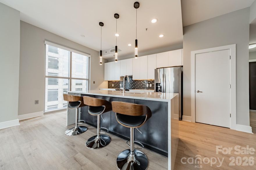 Experience elevated Uptown living in this beautifully renovated 2-bedroom, 2-bath residence Corner Unit at Charlotte’s iconic Trademark building. This move-in-ready condo blends modern updates with the vibrant energy of city living, offering a bright, open layout framed by expansive windows and stunning urban views.

The interior features a renovated kitchen and updated bathrooms, including a refreshed primary bath and a fully updated guest bathroom, paired with brand-new HVAC and water heater for added comfort and peace of mind. Motorized blinds in the kitchen and dining area add a sleek, contemporary touch while enhancing convenience and privacy. The open-concept living, dining, and kitchen spaces flow seamlessly ideal for entertaining or unwinding after a day in Uptown.

The split-bedroom floor plan provides excellent privacy, with a spacious primary suite and a well-appointed secondary bedroom perfect for guests, a home office, or flexible living. Natural light fills the unit throughout the day, highlighting the clean lines, modern finishes, and warm flooring showcased in every room.

Trademark is renowned for its resort-style amenities, including a rooftop pool and sundeck with skyline views, fitness center, club room, outdoor grills, and secure access with gated parking. Located just steps from Truist Field, Romare Bearden Park, Bank of America Stadium, the light rail, and Uptown’s best dining, entertainment, and cultural destinations, this home delivers unmatched walkability and lifestyle convenience.

Whether you’re searching for a primary residence, city retreat, or smart Uptown investment, this fully updated 2-bedroom condo offers the perfect combination of location, renovations, and modern urban sophistication in one of Charlotte’s most desirable high-rise communities.