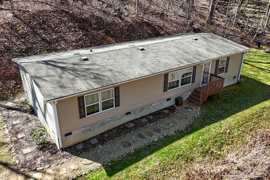 Private acreage, usable land, and room to grow—this is the kind of property that’s getting harder to find in Haywood County.

Situated on 3.36 acres, 256 Inglewood Cove Rd offers a rare combination of space, privacy, and functionality. The land has been extensively improved to create a true, usable yard—giving you room to gather, relax, and actually enjoy the outdoors without the limitations of typical mountain terrain.

This well-maintained 2018 home features a bright, open layout with updated fixtures in the kitchen, bathrooms, and dining area, creating a clean and cohesive feel. The primary bedroom includes a dedicated flex space addition currently used as an office—ideal for remote work, hobbies, or additional living needs. Note: walls to the flex space in the office are easily taken down.

Beyond the home itself, the property continues to stand out. With ample parking and generous acreage, there is potential for a future build site (buyer to verify), making this an excellent option for those thinking long-term—whether for a guest home, investment, or expansion.

Located just 10 minutes to both Waynesville and Maggie Valley, you get the best of both worlds: privacy and convenience. Asheville is also within easy reach for dining, shopping, and entertainment.

Light HOA with well-maintained roads and snow removal adds to the ease of living here year-round.

If you’ve been looking for usable land, flexibility, and a move-in ready home in a peaceful setting, this property delivers a unique opportunity.

Note: While Zillow indicates a flood zone, the current owner does not carry flood insurance.