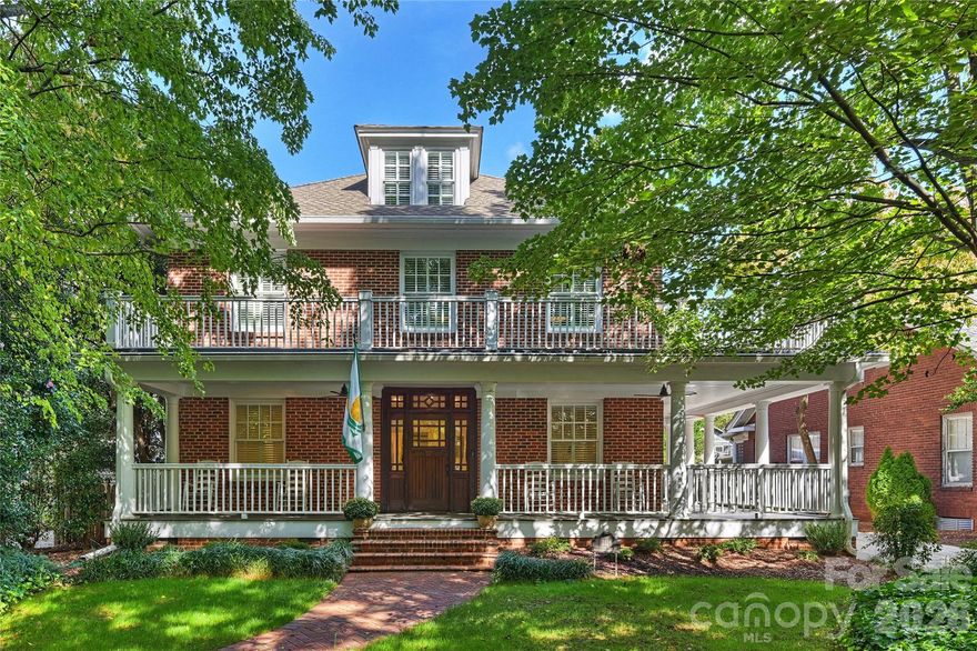 Timeless Elegance Meets Modern Comfort in the Heart of Dilworth. Nestled along prestigious Dilworth Road East, this exceptional residence seamlessly blends classic charm with contemporary sophistication. Offering approximately 4,500 square feet of living space, the home features six bedrooms, four full bathrooms, and a versatile main-floor office with easy access to a nearby full bath—perfect for use as a guest suite or the sixth bedroom. An inviting wraparound rocking-chair front porch sets the tone for the refined details found throughout. Inside, the open-concept main level is designed for effortless entertaining, anchored by a chef’s kitchen equipped with a Wolf cooktop, stainless steel appliances, double ovens, and an oversized quartz island. The kitchen flows gracefully into a sun-drenched sitting room and extends to a rear patio overlooking a tranquil backyard framed by brick walls and lush landscaping—an intimate retreat for quiet moments or lively gatherings. Elegant moldings, rich hardwood floors, and two fireplaces—one in the living room and another shared between the family room and kitchen—create a warm and inviting atmosphere. The spacious owner’s retreat is a true sanctuary, featuring a cozy fireplace, spa-like en-suite bath, and a generous walk-in closet. Upstairs, a full bar and entertainment area provide the perfect setting for hosting guests or enjoying relaxing evenings at home. This home offers a rare blend of historic character and modern amenities, all just moments from Dilworth’s premier shops, restaurants, parks, and minutes to Uptown and SouthPark.