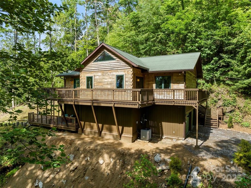 Motivated seller! Bring us an offer! Welcome to this stunning, fully-renovated modern cabin, nestled on 1.38 acres of pristine, undisturbed land. This spacious home features an open floor plan that seamlessly connects the living, dining and kitchen areas-perfect for entertaining or relaxing in comfort. With three generously sized bedrooms, each with its own en-suite bathroom, privacy and convenience abound. Enjoy the expansive wrap-around balconies and lower deck, offering breathtaking views of the surrounding natural beauty. A two-car garage provides ample storage and parking. Experience the perfect blend of modern amenities and rustic charm in the peaceful mountain retreat.