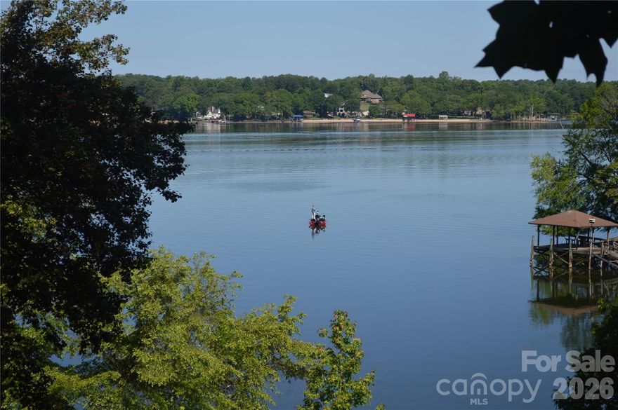 If you have been searching for a lake property that is located with some of the most spectacular views and location on Lake Wylie you have found it.  Whether you are interested in having a location you can run out to on weekends, building your dream home on a great waterfront property with gorgeous views located in the Southwest corridor of Charlotte, you have found your home!
Located directly beside the Palisades master planned community which is home to The Palisades Country Club boasting a Jack Nicklaus Design Golf Course with a tremendous tennis, swim, fitness and pickleball complex, and walking trails throughout. The best part of this waterfront home and location is that you have the opportunity to join the country club without having HOA restrictions. If you love boating, the home has an entire corner of main channel views and the dock is situated on the side along a cove so your views are unobstructed.  If you are looking for the perfect investment in waterfront property, come visit and see the home!
