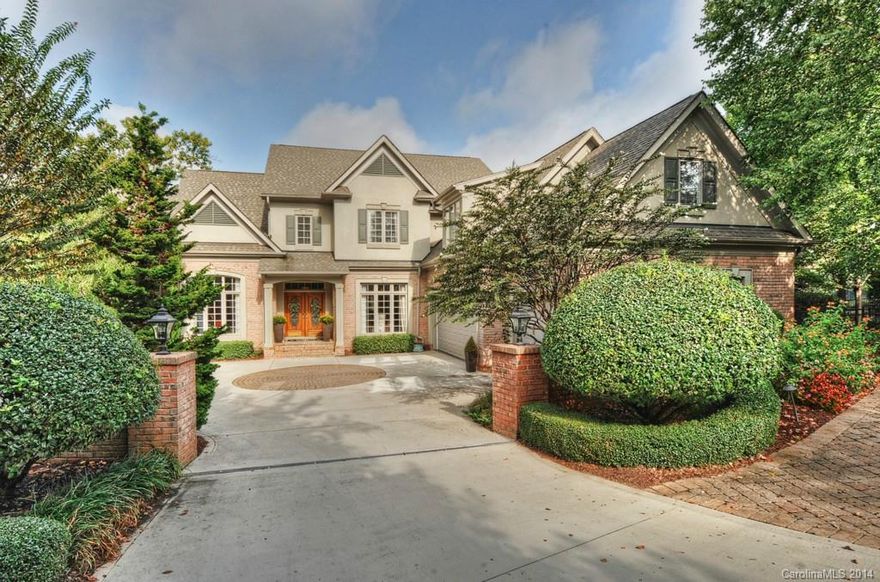 Ballantyne Country Club exclusive brick home located on a cul-de-sac on the #13 green w/panoramic views of the golf course & pond. With just over 7,600 sq ft & 3 levels of living space, this engaging and beautiful bsmt home has 6 BR's, 5.2 BA's, terrace, patios and screened porch. Resort setting with oasis pool, hot tub, swim-up bar seats, a true waterslide & waterfall! Outdoor fireplace, Koi Pond, kitchen w/grill, fridge & sink-a wonderful home filled with amenities for entertaining & comfort.