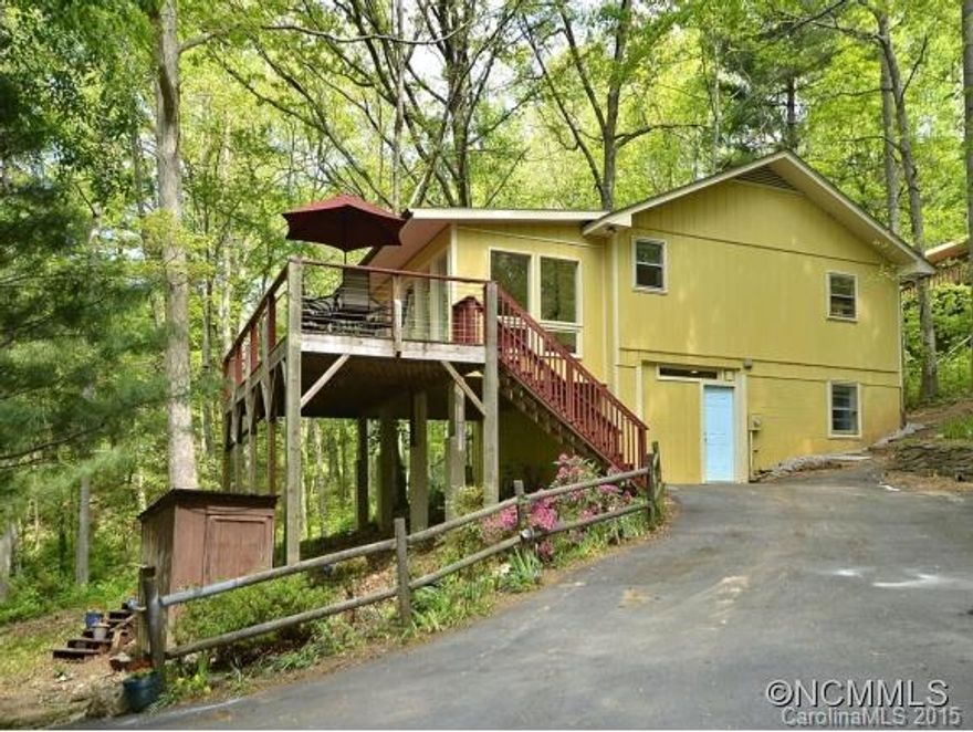 Enjoy the quiet solitude of this large private wooded lot while sitting on the expansive deck. Enter into bright updated sunroom that flows into open floor plan of kitchen, dining & living area. Gas log fireplace keeps main level toasty warm. Lower level bonus flex room perfect for office or kids. Large fenced in area off back porch. Great Riceville Forest location - just minutes to downtown Asheville! Move in ready - CUTE CUTE CUTE!