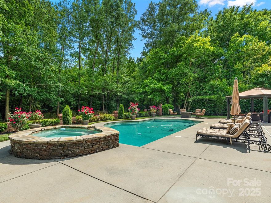 Summertime Splendor at this true gem in the sought-after Providence Country Club, where sophistication meets serenity. Tucked away on a private, manicured 1.25-acre lot, this full-brick stunner boasts 4 or 5 beds, 3.5 ba, two expansive bonus rooms, and a show-stopping saltwater pool & spa, designed to elevate your lifestyle. Newly refinished hardwoods lead through a flexible open floor plan, where the great room and sunroom lead to a generous family/game room, the perfect hub for indoor-outdoor entertaining. The upper-level primary with new luxury bath and captivating views is a private haven. Generous secondary bedrooms, three stylishly updated bathrooms, and an oversized bonus/flex room offer flexibility. Many upgrades throughout to enhance flow & function. Outdoors, every detail is curated for comfort & connection-from quiet mornings to vibrant evenings poolside. Don’t miss this exceptional opportunity to own one of Providence CC's most captivating and private properties.