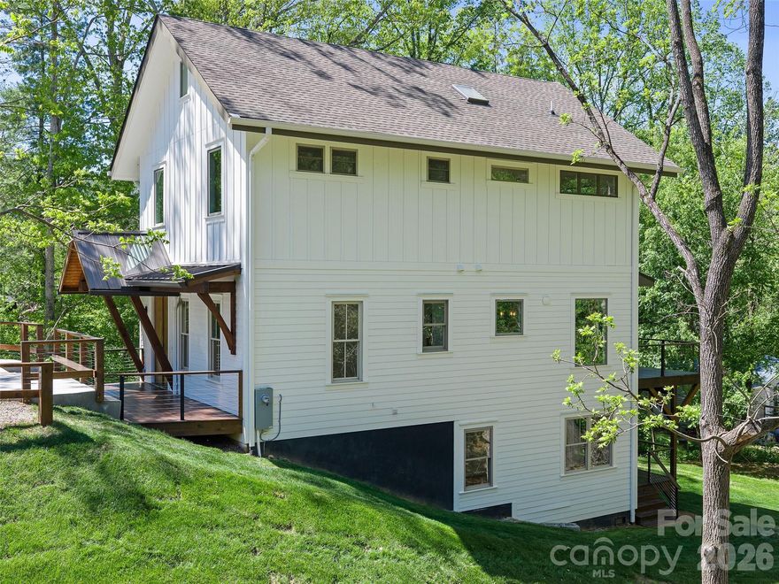 New construction craftsman style home with pleasing contemporary architectural design, smart stucco exterior and metal roof, conveniently located in the Biltmore Pines subdivision of central Asheville, with easy access to Asheville amenities.  Rapid access to interstate 40 and 240. Three bedrooms upstairs, including main bedroom, with spacious walk in closet, luxurious ensuite full bath, hall laundry room, and two guest bedrooms with full hall bath. Main level with open design living dining kitchen area with coffered ceilings, and fireplace.  Spacious kitchen with island and new appliances. A half bath off the entrance foyer.  Basement suite is connected to the upstairs with full staircase. The fully finished basement suite has step out access to back yard. Basement has an open design living-dining-kitchen area with a second laundry, a large BR, full bath and spacious closet space.  All closets have numerous built in features.  All construction of high quality and finish. Walkable back yard with new sod.  Private paved parking area in front of house level with paved city street containing room to easily park 3 cars.  Spacious attic storage with pull down stairs.  Helpful feature is that the attic could be connected to upper floor for additional third story bedrooms.