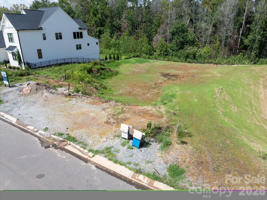LAST CHANCE!  A rare opportunity to build a brand-new home on the last remaining basement homesite in sought after Arden Mill. This .25-acre wooded homesite backs to a beautiful walking trail with wooded views to the rear.

This is a land sale with a required build agreement. Buyers select from a curated collection of architect-designed floor plans and personalize their home's finishes, fixtures, and selections through an on-site design studio. Due to the natural grade of this homesite, all builds require a basement floor plan — a tremendous opportunity to maximize living space and take full advantage of the wooded, sloped terrain. Available floor plans range from approximately 5,346 to over 6,600 square feet of heated living area with pricing starting from the upper $1.4M range, including lot.

Conveniently located just minutes from charming Downtown Fort Mill with its local shops and restaurants, nearby Anne Springs Close Greenway, and the Ballantyne area, the neighborhood is easily accessible from both I-77, South Charlotte and uptown Charlotte via I-485. Served by top ranked Fort Mill Schools including Catawba Ridge High,, Banks Trail Middle, and River Trail Elementary

Three car Side-entry garage included. Do not walk the lot without a scheduled appointment. Contact listing agent for available basement floor plans, site plan, and build program details.