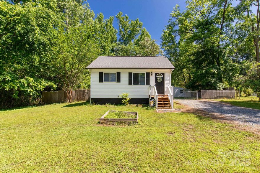 Cute 2 bedroom/1 bath on .96 acre lot with woods & creek.  New windows, new LVP flooring, & new window blinds.  Open floor plan with vaulted living room & primary bedroom with wood ceilings and paneled walls w/adjacent private deck.  Open loft above living room with railings and 5' tall height with built in bed.  Kitchen has laminate countertops, range/oven, microwave, and refrigerator.  Large bathroom with walk-in shower, closet with washer/dryer and washer/dryer remains.  New vapor barrier in the crawl space.  Partially fenced rear yard with large deck space and storage building.  Close to downtown Clover, restaurants, schools & shopping.