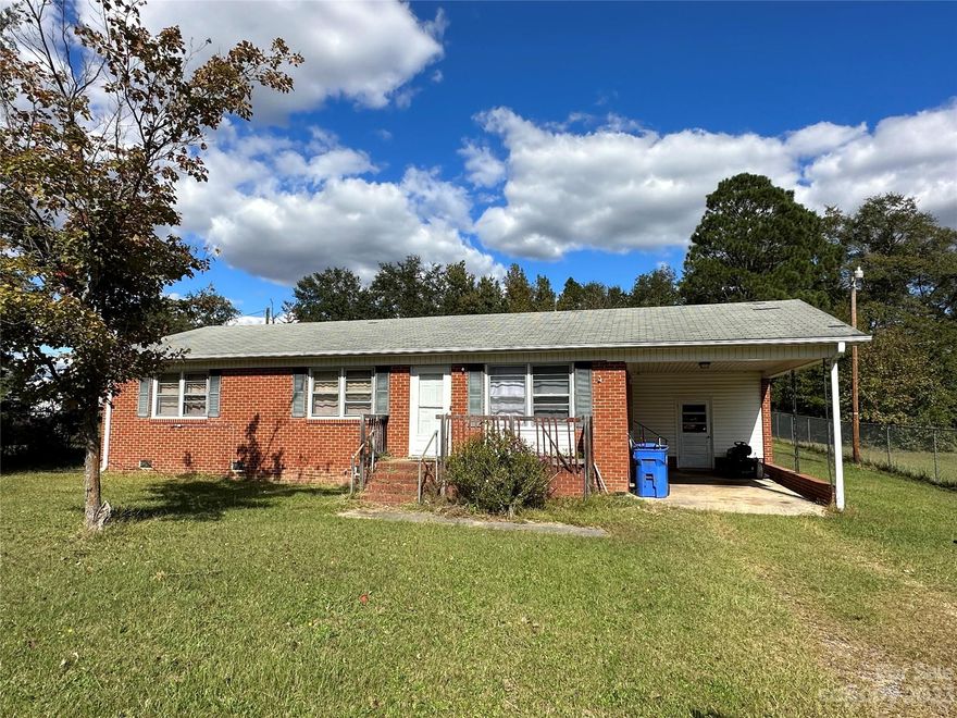 Make this brick ranch house a home, with your own repairs and update ideas.  It is located in an established Pageland neighborhood, close to area amenities, and is surrounded by a chain link fence.  It features a spacious kitchen/dining area, living room, three bedrooms and one full bathroom. There is an attached carport with laundry/ storage.