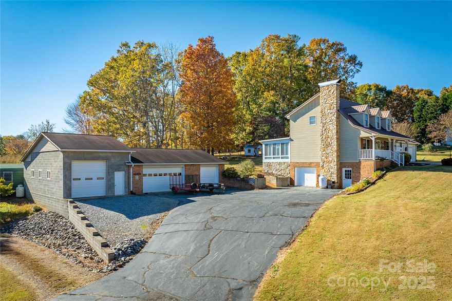 Welcome to this charming property that offers 7 garage spaces! It’s a perfect blend of comfort and functionality. Featuring an abundance of space, this home is ideal for those seeking room to grow! With loads of parking available, you'll find both a spacious workshop and a detached garage, providing ample room for hobbies or projects. It also includes the car lift and a 7 horsepower air compressor. It's heated by a propane unit and wood stove. The inviting sunroom at the back of the house offers a serene spot to relax and enjoy the views of the beautifully landscaped yard. Inside, the living room boasts stunning wood ceilings and a cozy stone fireplace, creating a warm atmosphere for gatherings. The kitchen is well-appointed, featuring stainless steel appliances and ample cabinetry for all your culinary needs. This home is situated on a generous lot, surrounded by nature, making it a peaceful retreat while still being conveniently close to local amenities. Don't miss the chance to make this beautiful residence your own!