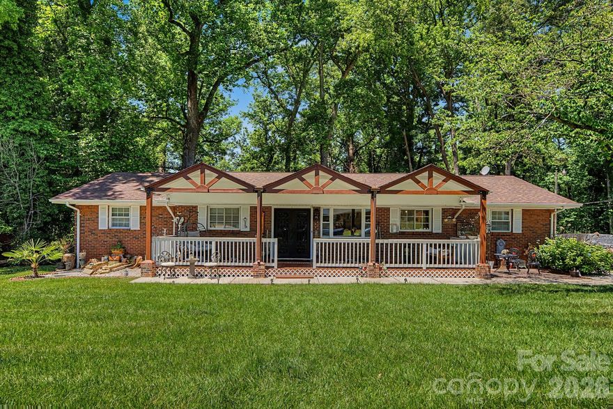 Stunningly beautiful and updated full brick ranch nestled in 0.45 aprox. acres, in a lovely established neighborhood; convenient to I-85 & I-77 and uptown Charlotte. This beautiful home features: 4 Bedrooms and 3 Full bathrooms. Updated kitchen, with custom cabinets, elegant granite countertops, stylish tile backsplash and a large center island perfect for cooking and gathering. Ceramic tile flooring on kitchen and bathrooms.  Updated light fixtures.  Bathrooms with luxurious glass walk-in showers.  Yard professionally landscaped.  Gorgeous front porch.