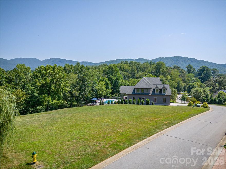 This exceptional, gently sloping parcel is nestled within a highly sought-after community of custom estate homes. One of the final remaining lots, it offers a rare and ideal opportunity to build your dream home in a truly breathtaking setting. The property captures sweeping views of the Western North Carolina mountains in every direction. The topography is perfectly suited for a walk-out basement, while still providing ample outdoor space for entertaining and everyday enjoyment. A tree-lined backdrop enhances privacy, with seasonal mountain views adding to the property’s natural charm. Residents enjoy underground utilities, scenic hiking trails, a tranquil pond, and postcard-worthy vistas—all complemented by crisp, refreshing mountain air.  Experience peaceful, refined living just a short drive from the vibrant amenities of Asheville and Hendersonville. This is your chance to create something truly special in an unforgettable location.