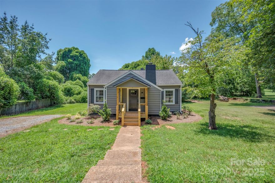 Beautifully Updated Home Blending Charm and Functionality! This adorable home features tongue-and-groove ceilings, classic archways, and a cozy fireplace. The updated kitchen showcases butcher block countertops, tile backsplash, modern cabinetry, and stainless steel appliances. Fresh paint and updated flooring run throughout the home. The spacious primary suite includes a walk-in closet and a stunning new bathroom with a tiled shower and double vanity. A second full bath offers a tub with tile surround. Outside, enjoy the new front porch and beautifully landscaped yard—perfect for relaxing or entertaining. Additional updates include new plumbing, electrical, and a new HVAC system—all permitted and installed by licensed professionals. Conveniently located close to all that Forest City has to offer!