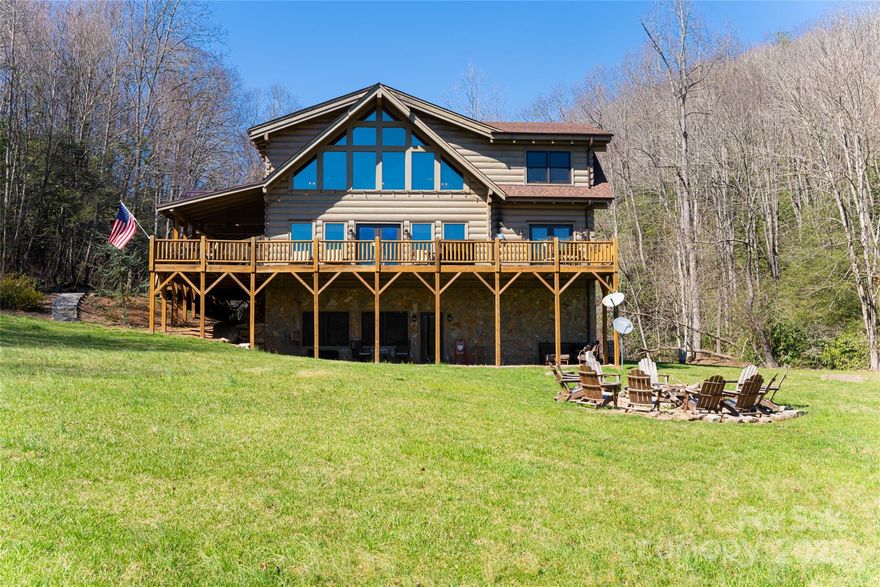 Quintessential log cabin situated on 14+, private acres with a sprawling, flat meadow, a bold creek that runs the property line, and a wooded hillside that offers endless possibilities for outdoor recreation or additional building sites. A large, wraparound porch welcomes you to this inviting cabin with a rich, log interior that features an open floor plan, hardwood floors, a vaulted ceiling in the living room and stone fireplace. The large kitchen includes stainless steel appliances, granite countertops, and an oversized eat-in island. The spacious, main level primary suite features a stone fireplace, exterior deck access, a large walk-in closet, and a luxurious ensuite with double vanities and a walk-in tile shower. The upper level includes two guest suites and a generous loft area. The basement comprises an ample family room, recreation area, fourth bedroom, a bonus/bedroom, laundry room, and ample storage. Please no drive-bys. HIGHEST AND BEST DUE BY 3-17-25 @ 12PM.