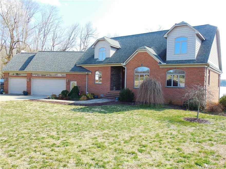 Fantastic view of lake from many rooms, 2 screened porches and patios.  Wood, tile floors throughout.  Gourmet chef's kitchen, granite tops, stainless-steel appliances, center island, & walk in pantry - loads of storage space! Great Room with vaulted ceilings and breathtaking stone floor-to-ceiling wood-burning fireplace. Dining overlooks water.  (2) 2nd-story screened porches. 3-car garage, tremendous potential in large walk-out basement. Over an acre of property! Pier with nice floating dock.