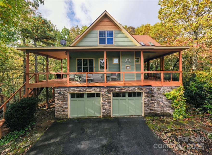 Perched at 3,500 feet between Fairview and Black Mountain, this stunning mountain retreat offers sweeping views and luxurious comfort in the heart of WNC. Recently renovated inside and out, the home features new HVAC, tankless water heater, fresh paint, and designer finishes throughout. The main level welcomes you with an open floor plan, stone fireplace, and a chef’s kitchen with custom cabinetry, imported European doors, butler’s pantry, and heated tile floors. The primary suite has direct access to the deck with breathtaking views, and includes a spa-like bath with soaking tub, tile shower, dual vanity, and antique barn doors. Upstairs, a spacious loft, two bedrooms, and full bath provide ample guest space, while the finished basement adds a bonus room for sleeping or rec room, full bath, and laundry. Outside, enjoy wraparound decks on three sides, a hot tub, and a wooded fire pit—perfect for entertaining, stargazing, or quiet mornings with coffee. Sold fully turn-key, this home is ideal as a short term rental or your own private mountain sanctuary.