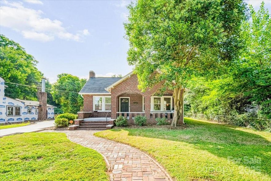 Charming full brick home with cozy front porch features 3 Bedrooms, 2 Baths blending original character with thoughtful updates! Living room with brick fireplace, large dining room perfect for entertaining and front bedroom with built-ins. Gorgeous original hardwood floors in bedrooms, living, dining, and halls. Updated kitchen with white cabinets, granite counters, stainless appliances, and wood look tile flooring that continues into the coffee bar/butler’s pantry, laundry and sunny utility/sunroom. Both the owner's suite and secondary bath feature white cabinetry, granite counters, and tiled floors. Oversized new concrete driveway with abundant parking, and added walkway. A partial basement and rear shed (320± sf rear shed 26'x12.3') provides coveted storage space. Walk to Confederate Park with trails, tennis, courts, and playground. Just minutes to downtown Rock Hill, Fountain Park, Main Street Children's Museum, Winthrop University, local shops, breweries, & more!