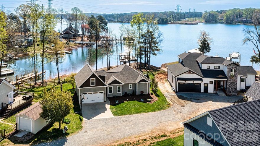 Welcome to Dockside at Songbird — a turnkey Lake Norman waterfront escape featuring serene lake views, abundant windows, granite countertops, solid hardwood flooring, and an additional 400 sq ft finished bonus room above the garage.

Perfectly positioned for the lake lover, this beautifully maintained home offers effortless access to boating, paddleboarding, and kayaking directly from your private dock, with water depth suitable for year-round boating. Whether you're cruising to waterfront restaurants or enjoying a quiet morning on the lake, this is the lifestyle that draws buyers to Lake Norman.

The exterior showcases a combination of HardiPlank siding and cedar shake accents, offering low-maintenance durability with timeless architectural appeal. Inside, a thoughtfully designed 1,247 sq ft, 2-bedroom, 2-bath open-concept layout is enhanced by solid hardwood flooring and granite countertops. The additional 367 sq ft finished bonus space above the garage provides the perfect setting for a private home office, media lounge, or creative studio. Abundant windows fill the home with natural light while showcasing serene lake views.

Step outside and the experience continues. The private dock, complete with a charming gazebo and swing, creates the perfect setting for hosting friends, relaxing in the evenings, or simply taking in the peaceful lake views.

Recent updates and features include a new roof (2023), HVAC (Feb 2025), Hague WaterMax whole-house filtration system, approximately 120 feet of shoreline riprap (2022), and a Hot Spring Highlife therapeutic saltwater spa (2024), adding to the home’s comfort and relaxation.

The low-maintenance fenced yard allows for easy living, while the 2-car garage and additional storage provide everyday functionality.

It’s not just a home — it’s a place to gather, relax, and make lasting memories on the lake.