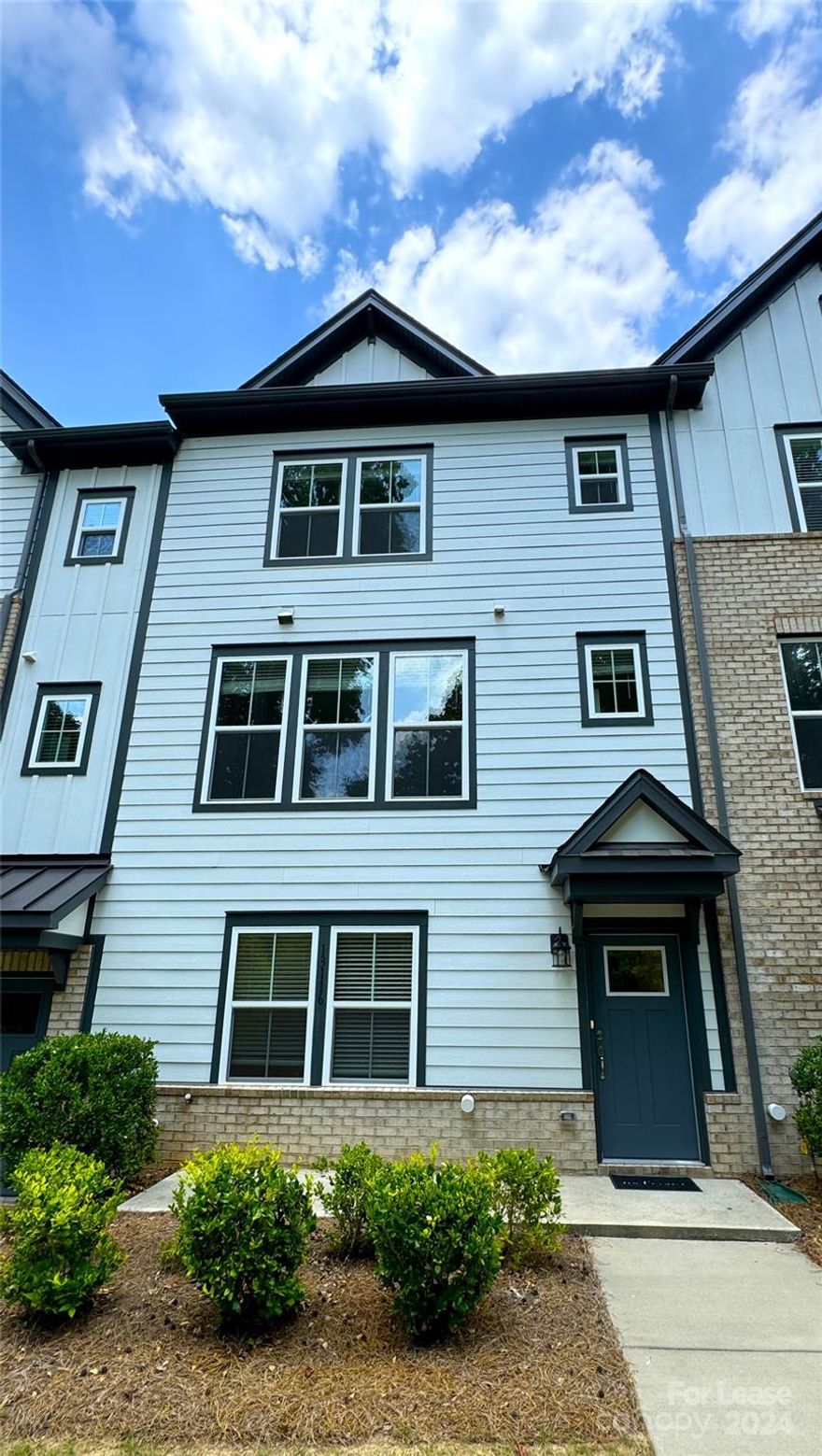 Beautifully maintained townhome in Ballantyne! built in 2022, this modern townhome sits right in b/n Stonecrest & Blakeney shopping centers in Elm at Stonecrest community. 3 levels of thoughtful, flowing space provides an assortment of living options. Come home and park in the 2 car attached garage w expanded storage area. Built in bench with coat hooks and storage cubbies opens to flex room perfect for home office, fitness area, or game room. 2nd lvl offers oversized kit island with SS appliance package - dbl oven, gas range, microwave, and fridge complete the home chef's needs. Breakfast area flows through the kit into the gathering room and expands further to the balcony overlooking the community. 3rd lvl provides owner's suite complete with walk in closet, dual vanity sink, and oversize tile shower. BRs 2 & 3 offer large closets and privacy. 2nd full BA includes shower / tub combo with large vanity. Shopping, dining, fitness and community resources all within walking distance