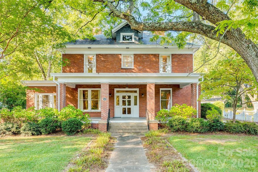 Step inside this timeless two-story brick home in the heart of the Historic District of York, SC, located on one of the most charming streets in York County and just a short walk to downtown York’s shops, dining, and community events. A classic rocking chair front porch sets the tone, welcoming you into grand, high-ceilinged rooms with original hardwood floors and beautiful built-ins that showcase the home’s character and Southern charm. Fresh interior paint brightens the living spaces, while fresh landscaping enhances the curb appeal, blending historic beauty with thoughtful updates. The formal dining room is ideal for gatherings, and the sunroom offers a bright retreat for morning coffee or afternoon reading. A mudroom adds everyday functionality without sacrificing historic style. Out back, a rare find for a historic York home, a detached two-story garage offers incredible flexibility. The main level provides parking and storage, while the upstairs bonus space is perfect for a guest suite, art studio, or home office. With its blend of historic charm, spacious interiors, fresh updates, and walkable location in Historic York, South Carolina, this home is ready for its next chapter.