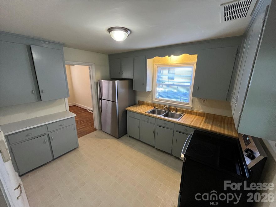 You will fall in love with this beautiful 3 bed, 1 bath 1,103 sq. ft. single-story home, accented with brick and blue shutters and surrounded by mature trees! You're welcomed into your spacious family room, perfect for entertaining guests, with gorgeous hardwood floors that continue throughout the home. The kitchen is equipped with stainless steal appliances and tons of cabinet space. The three bedrooms feature ceiling fans and large closets. The full bathroom is embellished with tile-accented walls. Another great feature is the sunroom, which overlooks the fenced-in backyard and opens to a concrete patio! The home is heated by gas and offers lots of parking in the long driveway! Located in the Country Club Heights community, near lots of dining, shopping, parks and recreation. Less than 15 minutes from Uptown Charlotte!