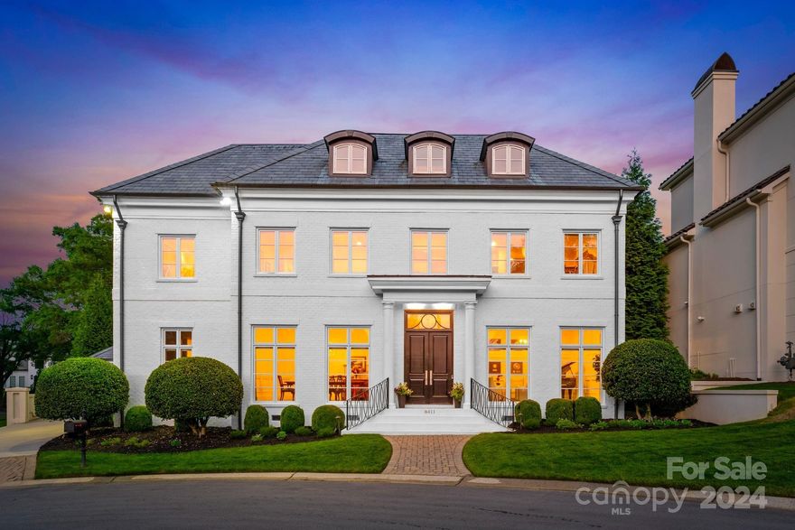 Prestigious custom home nestled in gated Seven Eagles neighborhood! This home exudes elegance and sophistication. Stately painted brick exterior, sleek slate roof, 10 1/2 ft ceilings on main, gleaming hardwood floors, intricate moldings and oversized windows & doors are just some of the many features of this home. Owner's suites on both main and upper levels with expansive walk-in closets & marble bathrooms. The gourmet kitchen opens to family room, with custom cabinetry, large center island, luxurious Calcutta gold marble countertops, marble backsplash, custom range hood & professional grade stainless appliances. Upper level offers secondary bedrooms, walk-in closets & en-suite baths, & large bonus room on second floor. Walk up unfinished 3rd floor is additional 1400+ ft. Outside, manicured grounds provide a serene backdrop with large privacy wall and fire pit, while being just steps away from a prestigious country club and golf course adds to the allure of this exceptional property.