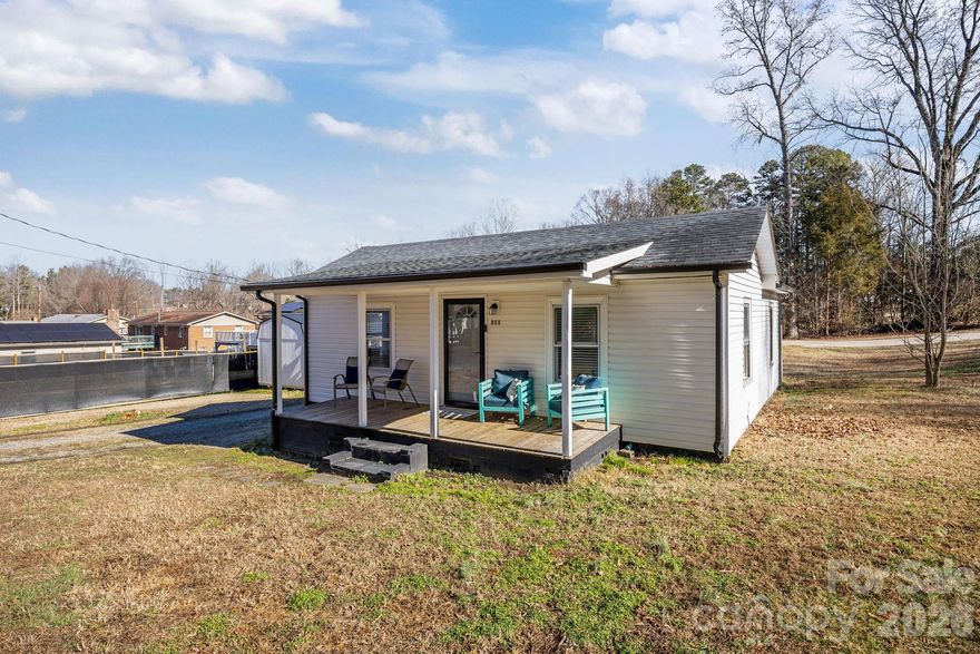 211 Franklin Ave is an updated single-family home conveniently located just minutes from downtown Kannapolis with quick access to Interstate 85, Highway 29, and Mooresville Road, making daily commuting simple and efficient. This 1940 mill home offers thoughtful interior updates presents a solid opportunity for first-time buyers, downsizers, or anyone seeking a move-in-ready home at an approachable price point. Inside, vinyl plank flooring runs throughout the home, creating a clean and cohesive feel. The kitchen features white shaker-style cabinetry with polished chrome hardware, granite countertops, and a full appliance package including a stove, refrigerator, microwave, and dishwasher, with the dishwasher replaced in 2026. The bathroom includes a large solid-surface vanity with an under-mount sink, and a dedicated laundry area with stackable washer and dryer units adds everyday convenience. Situated on a corner lot, the property offers a welcoming front porch, a back deck, and a privacy-fenced backyard. A 10x16 storage building provides additional space for tools or equipment, while a Ring doorbell adds a modern touch. With its manageable size, practical updates, and convenient location near downtown and major commuter routes, 211 Franklin Ave offers a smart and affordable option in the heart of Kannapolis.