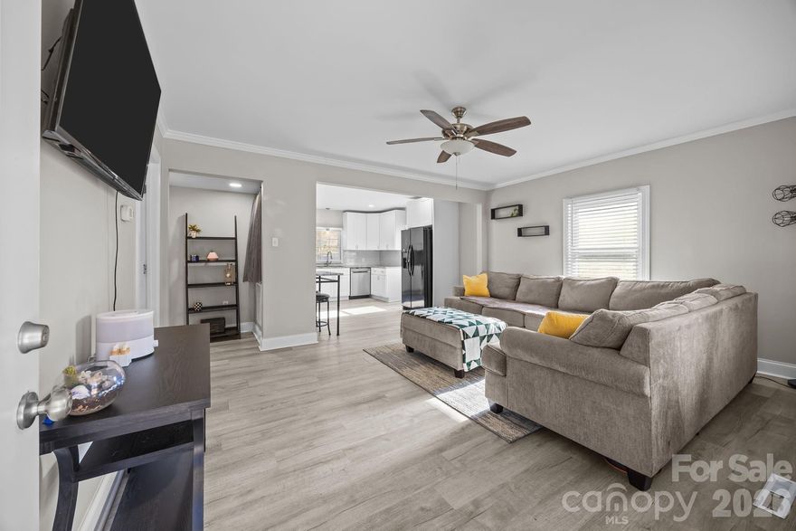 211 Franklin Ave is an updated single-family home conveniently located just minutes from downtown Kannapolis with quick access to Interstate 85, Highway 29, and Mooresville Road, making daily commuting simple and efficient. This 1940 mill home offers thoughtful interior updates presents a solid opportunity for first-time buyers, downsizers, or anyone seeking a move-in-ready home at an approachable price point. Inside, vinyl plank flooring runs throughout the home, creating a clean and cohesive feel. The kitchen features white shaker-style cabinetry with polished chrome hardware, granite countertops, and a full appliance package including a stove, refrigerator, microwave, and dishwasher, with the dishwasher replaced in 2026. The bathroom includes a large solid-surface vanity with an under-mount sink, and a dedicated laundry area with stackable washer and dryer units adds everyday convenience. Situated on a corner lot, the property offers a welcoming front porch, a back deck, and a privacy-fenced backyard. A 10x16 storage building provides additional space for tools or equipment, while a Ring doorbell adds a modern touch. With its manageable size, practical updates, and convenient location near downtown and major commuter routes, 211 Franklin Ave offers a smart and affordable option in the heart of Kannapolis.