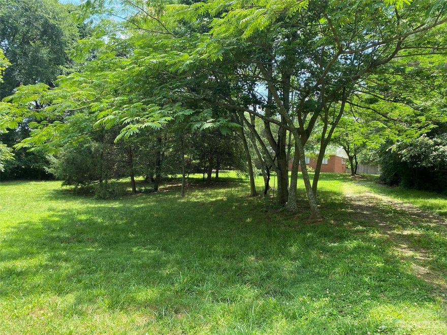 Come build your dream home on this privately situated 5.05 acres which is 2 parcels being sold together. (PIN #11113124 also)  You can have your piece of the country within a short distance to all the conveniences of town, just a couple miles to I485.  The back portion of the property is wooded and there's a small creek at the back.  There is a natural gas pipeline/city utilities easement running along the back but this can be used for pasture as long as gates are added to allow access for the utility companies.  The concrete block well house with attached shed was once used as a barn with chicken coop enclosed on the back of it.  The dwelling on the property can be renovated for a residence or as rental income.  The house is currently hooked to septic and was supplied by well water but the well water pump went out so the home is being sold as-is.  City water tap available at the road.  Don't let this hidden gem pass you by!  Make your appointment today!